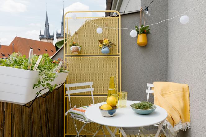 Mały balkon w bloku lub kamienicy z kolorem żółtym