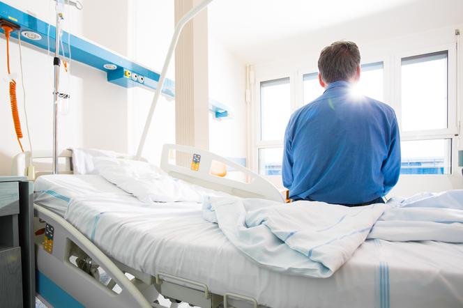Pacjent siedzący na łóżku szpitalnym