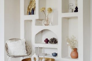 Regał w salonie nie musi wyglądać jak składzik przypadkowych rzeczy. Jak stylowo zaaranżować półki, które widać?