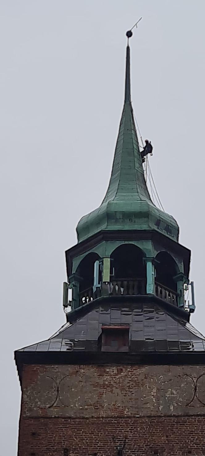 Alpinista na wieży kościoła w Białogardzie