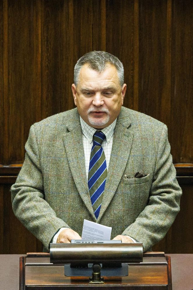 W czasie obrad Sejmu poseł przeglądał katalog z bronią