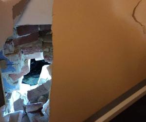 Samochód przebił ścianę domu, cegły pospały się na biurko