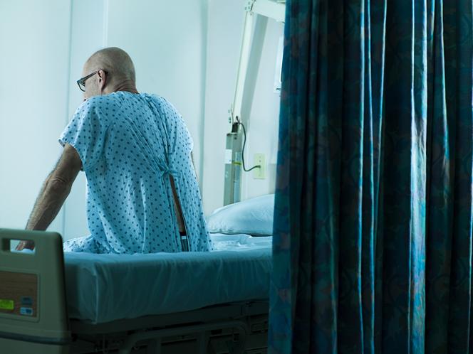 Mężczyzna siedzący w szpitalu na łóżku 