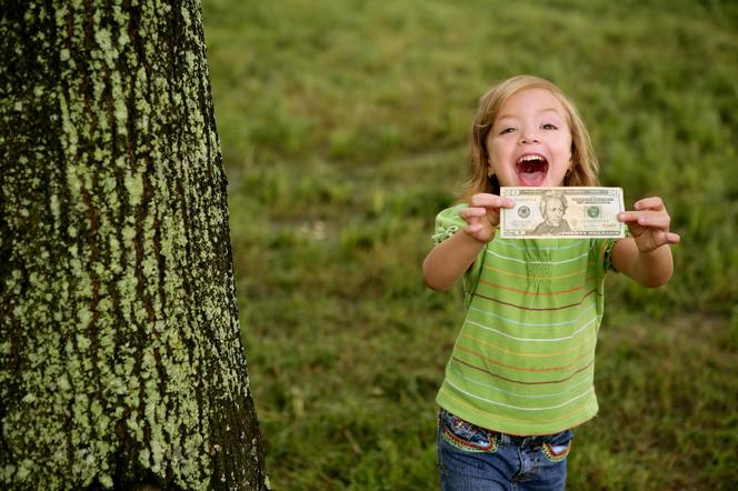 dziewczynka trzyma banknot