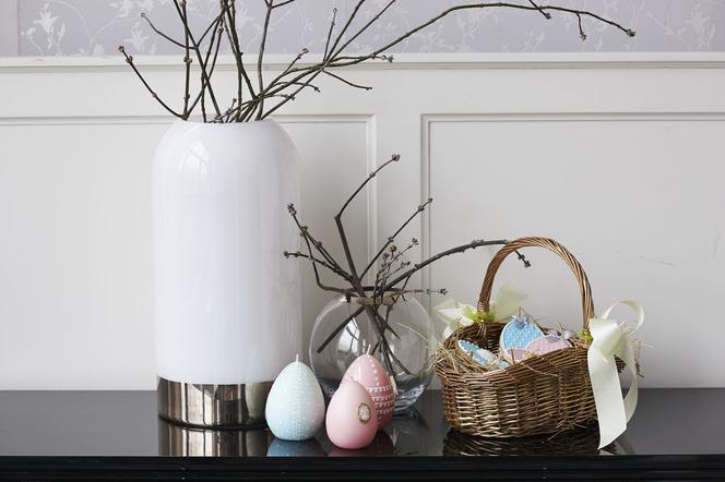 Gałęzie mirabelki w białym wazonie jako dekoracja stołu na Wielkanoc