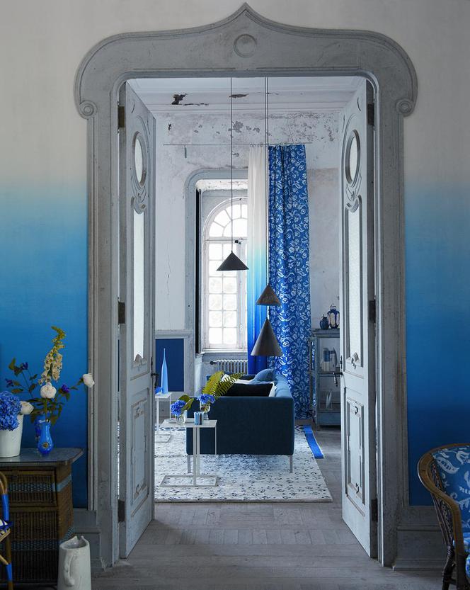Niebieskie takniny i tapety ombre w pokoju dziennym