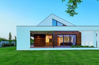 Dom o rozrzeźbionej, asymetrycznej bryle i prostym planie 