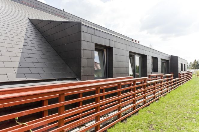 Oryginalna współczesna facjata, która w nowoczesnym projekcie domu pełni funkcję ściany bocznej budynku ścian