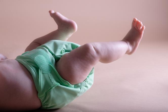 Nóżki niemowlęcia w zielonej pieluszce