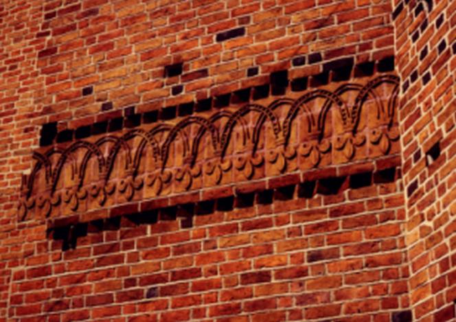 Ceramiczny ornament liliowy, fryz kościoła OO. Dominikanów w Krakowie (XIII w.)