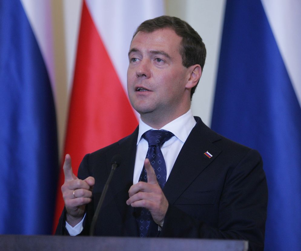 Dmitrij Miedwiediew przemawiający na tle flag Rosji i Polski, gestykulujący dłońmi podczas wygłaszania kontrowersyjnej propozycji przejęcia Belwederu. Więcej o rosyjskiej propozycji przeczytasz na naszym portalu.