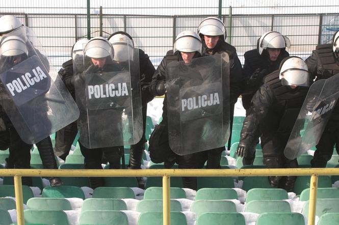 Policjanci na stadionie, mur policyjny, policja z tarczami, pałka policyjna