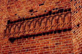 Ceramiczny ornament liliowy, fryz kościoła OO. Dominikanów w Krakowie (XIII w.)