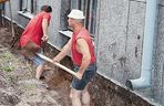 Podbijanie fundamentów kork 1. Zanim wykonano wykop, dookoła budynku usunięto ziemię roślinną, czyli humus. W narożnikach oraz w wybranych odcinkach podkopano ławę fundamentową