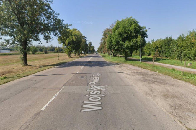 Ulica Wojska Polskiego w Łomży z widocznymi drzewami i polem. O szczegółach modernizacji drogi przeczytasz na Eska Łomża.