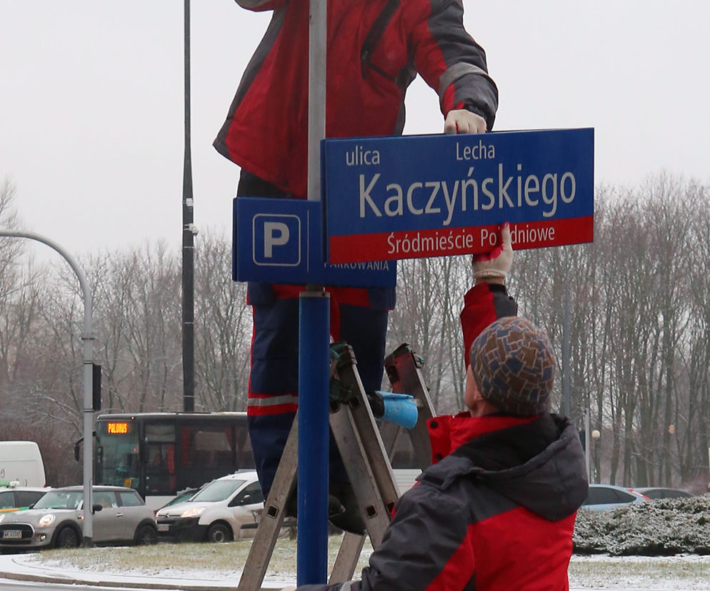 Dekomunizacja Warszawy. Zdejmowanie tablicy z Aleją Lecha Kaczyńskiego, zakładanie na powrót Armii Ludowej.