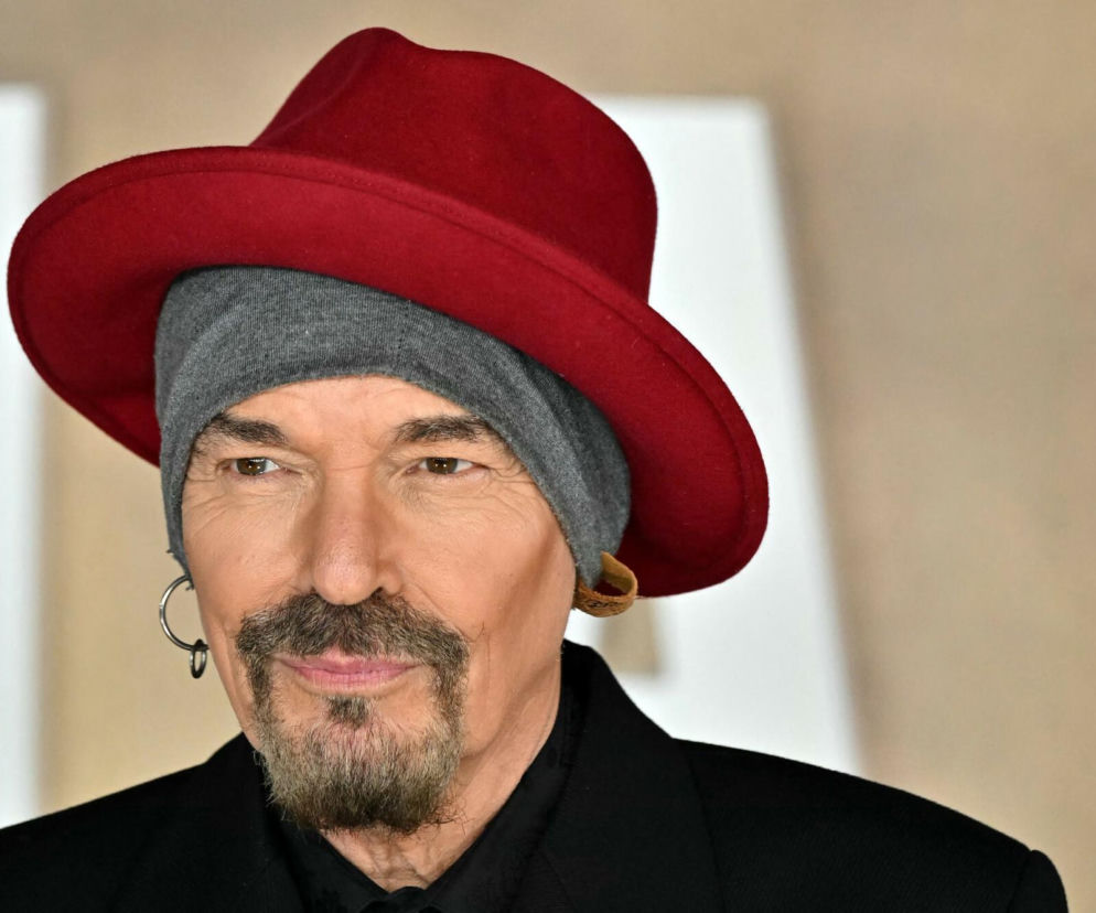 Aktor Billy Bob Thornton w czerwonym kapeluszu i siwej czapce. O jego pracy w branży rockowej przeczytasz na EskaRock.