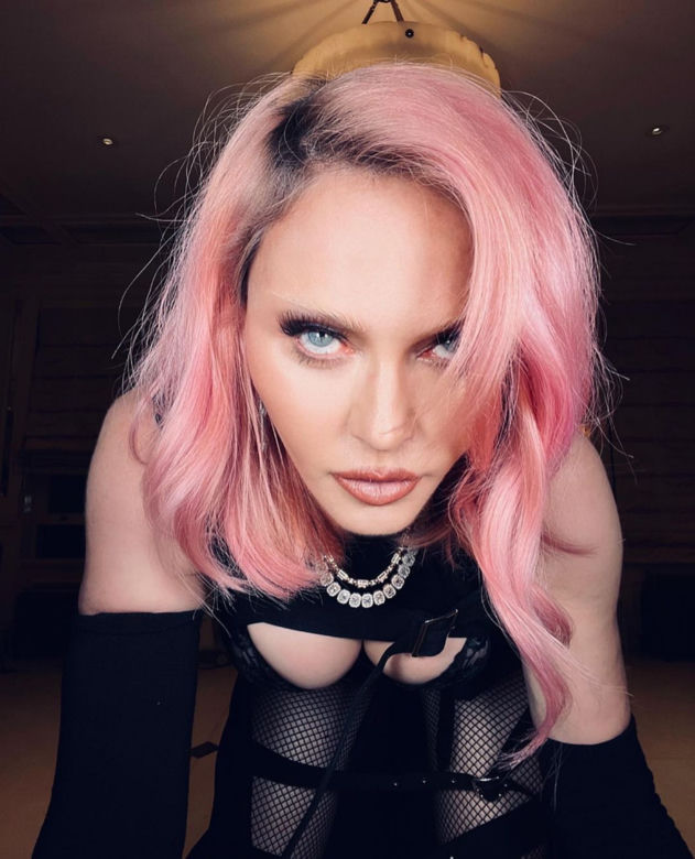 Madonna w kominiarce rzuca się w konwulsjach po łóżku. W ręce trzyma pejcz. "Ocknij się kobieto"