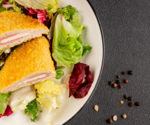 Kotlet cordon bleu. Chrupiąca panierka skrywa środek, który rozpływa się po przekrojeniu