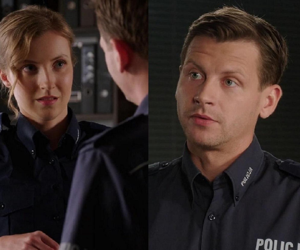 Młoda policjantka Natalka (Dominika Suchecka) spogląda na Adama Karskiego (Patryk Szwichtenberg) w mundurach, oboje z zamyślonymi minami, co odzwierciedla ich skomplikowaną relację. Więcej o ich losach dowiesz się na Super Seriale.