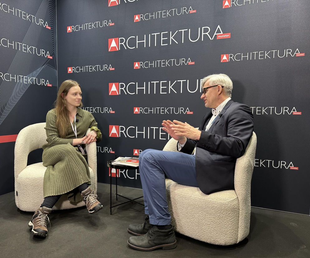 Wywiad z Szymonem Wojciechowskim z APA Wojciechowski, rozmawiającym z Karoliną Krasny na 4 Design Days, na tle ścianki z logo Architektura Murator. Dyskusja dotyczy modernizacji V Tower, o czym można przeczytać więcej na Architektura Murator Plus.