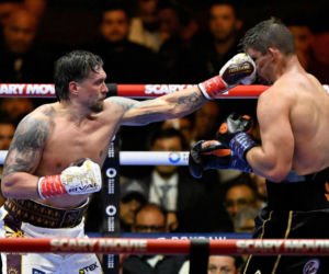 Ukraine's Oleksandr Usyk throws a flurry of punches at Netherlands' Rico Verhoeven