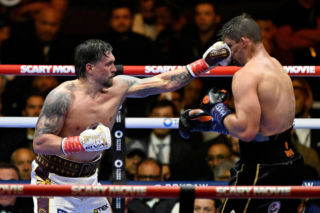 Ukraine's Oleksandr Usyk throws a flurry of punches at Netherlands' Rico Verhoeven