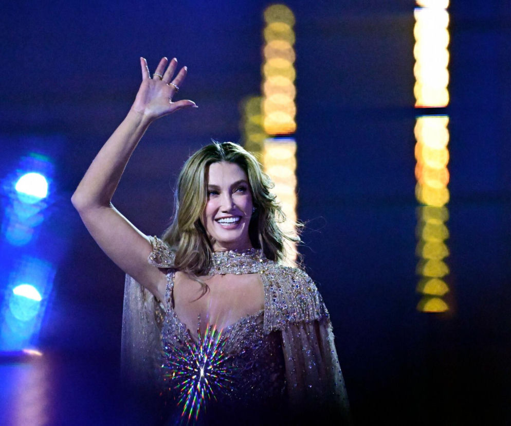 Uśmiechnięta Delta Goodrem macha ręką do publiczności. O trasie koncertowej artystki przeczytasz na Eska.