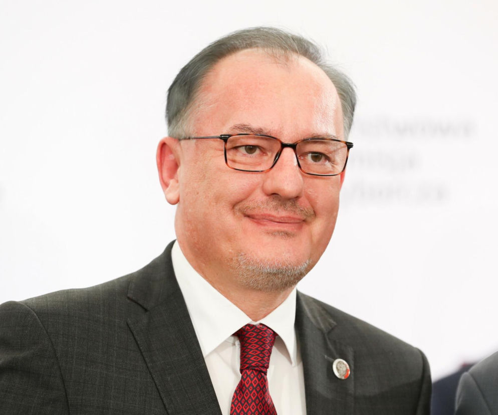 Senator Ryszard Majer w ciemnym garniturze i okularach uśmiecha się. O jego przejściu do Rozwoju Plus czytaj w SE Polityka.