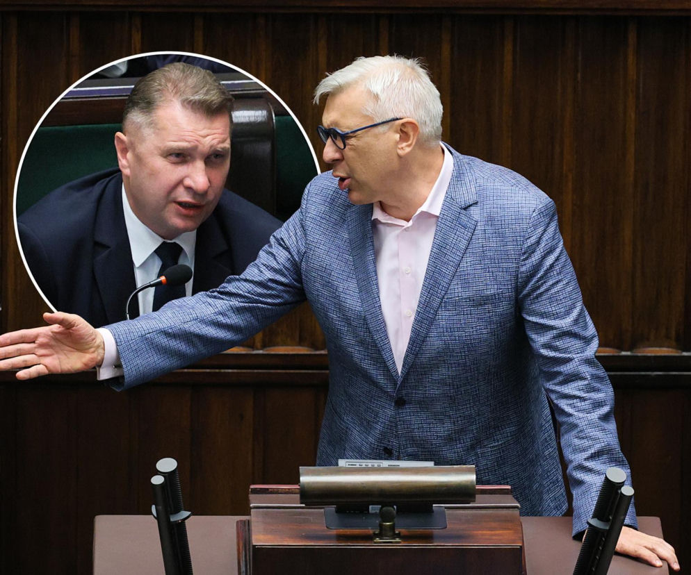 Dynamiczne starcie polityczne w Sejmie: Roman Giertych w błękitnej marynarce gestykuluje energicznie, stojąc przy mównicy. W tle, w okręgu, Przemysław Czarnek w garniturze wyraźnie niezadowolony. Scena oddaje intensywność debaty, o której czytaj więcej na naszym portalu.