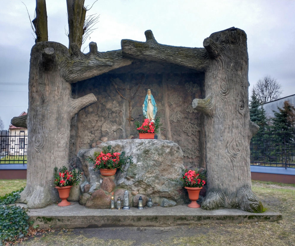 Betonowa grota w Osjakowie z figurą Matki Boskiej i kwiatami. O zabytkach miasta przeczytasz na Eska Łódź.