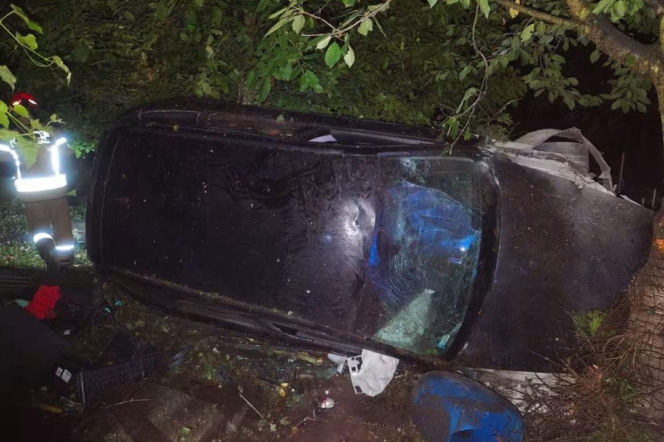 Czarne Audi leżące na boku po uderzeniu w drzewo w Przeworsku. O wypadku pijanego 21-latka czytaj w Eska Rzeszów.