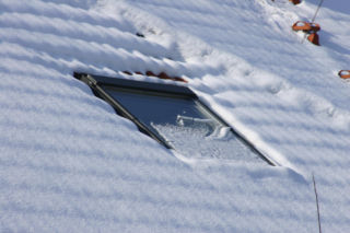 Okna dachowe zimą: Jak bezpiecznie usunąć śnieg i lód?