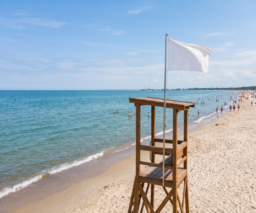 Drewniana wieża ratownika z białą flagą na plaży w Świnoujściu. O warunkach do kąpieli przeczytasz na SE Szczecin.