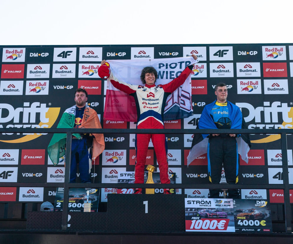 Piotr Więcek z polską flagą na najwyższym stopniu podium Drift Masters. O jego sukcesie przeczytasz na SE Supersport.