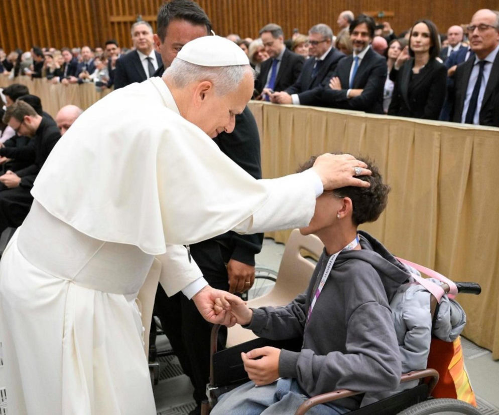 Pope Leo XIV blesses a young person in a wheelchair