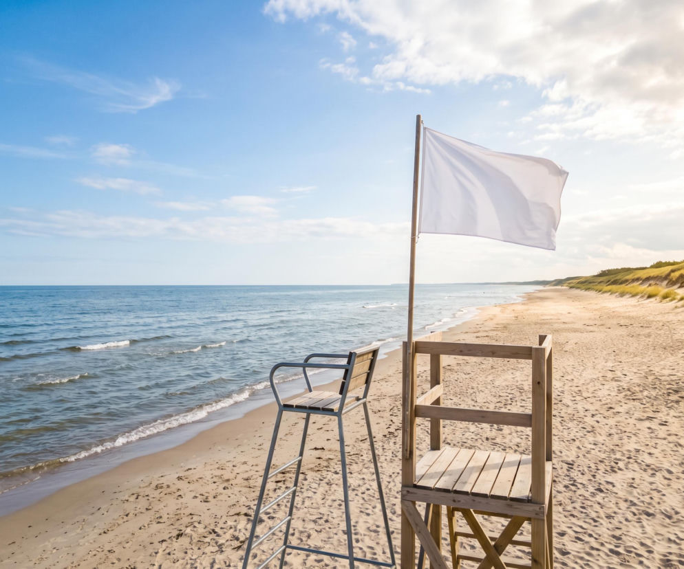 Biała flaga na pustej plaży w Pogorzelicy. O bezpiecznych kąpielach i braku sinic przeczytasz na SE Szczecin.