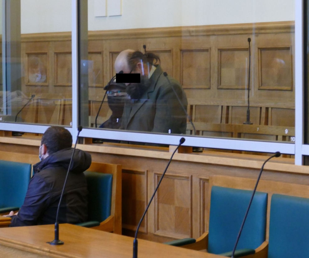 Prokurator rozpoczyna odczytywanie aktu oskarżenia. Mamuka K. Słucha go ze spuszczoną głową