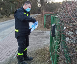 Strażacy z OSP dostarczają ulotki na temat szczepień do mieszkańców powiatu iławskiego