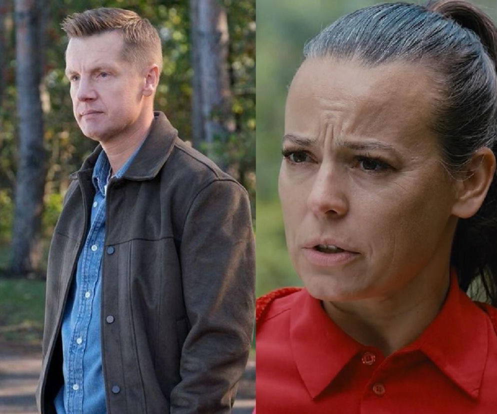 Rafał Mroczek jako Paweł Zduński i Anna Mucha jako Magda Budzyńska w serialu M jak miłość. Paweł, ubrany w koszulę i kurtkę, stoi w lesie, Magda z zaciśniętymi ustami ma włosy spięte w kucyk. Więcej o ich losach w Super Seriale.