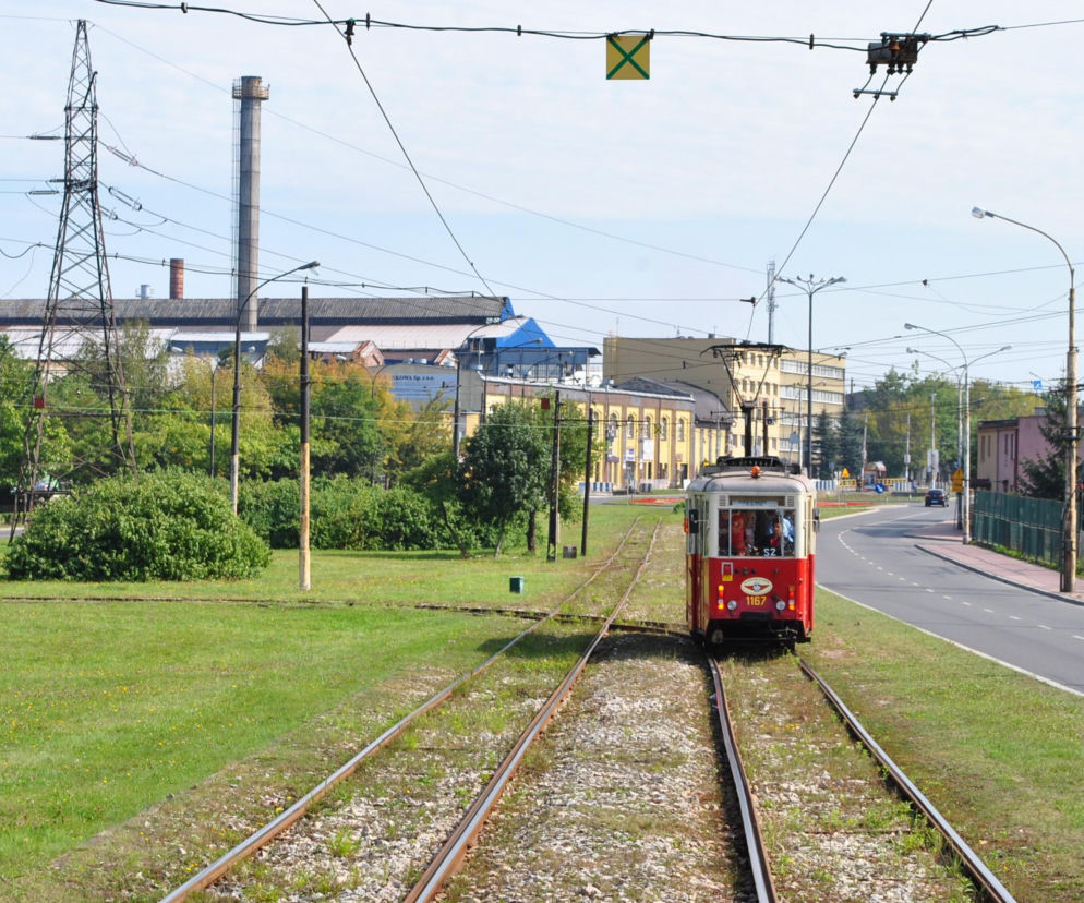 Czerwony zabytkowy tramwaj na torowisku w Dąbrowie Górniczej. O historii miasta przeczytasz na Eska Śląskie.