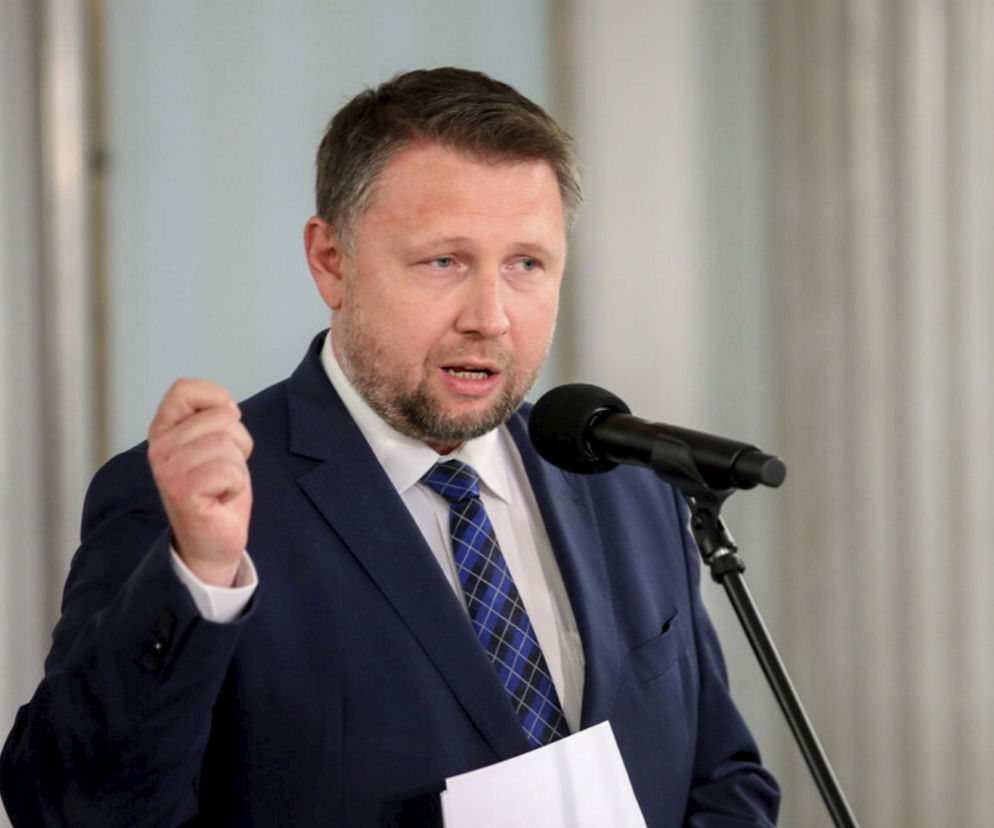 Minister Marcin Kierwiński przemawia do mikrofonu i wykonuje gest dłonią. O sporze z PiS przeczytasz na SE Polityka.