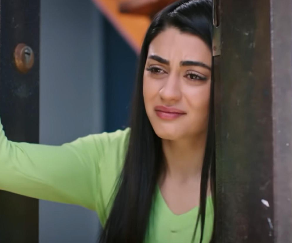 Hancer w zielonej bluzce, z długimi ciemnymi włosami, zmartwionym wyrazem twarzy, trzymająca otwarte drzwi, pogrążona w zamyśleniu. Scena z serialu Panna młoda, przedstawiająca dramatyczne wydarzenia z 60. odcinka. Więcej o losach bohaterów przeczytasz na portalu Super Seriale.