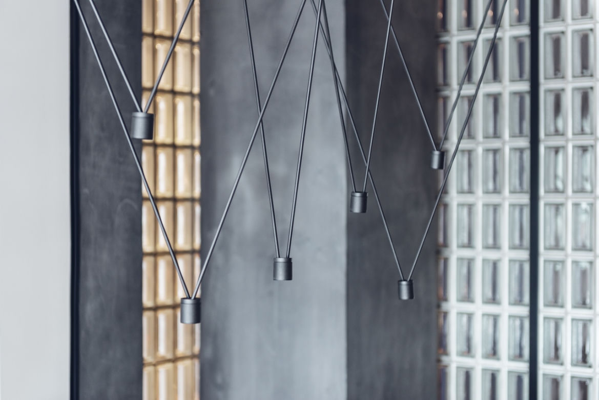 Nowoczesna lampa nad stołem w apartamencie młodego estety