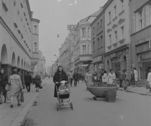 Widoczne zabytkowe kamienice. Na ulicy kobieta z dzieckiem w wózku, 1973-05-11 