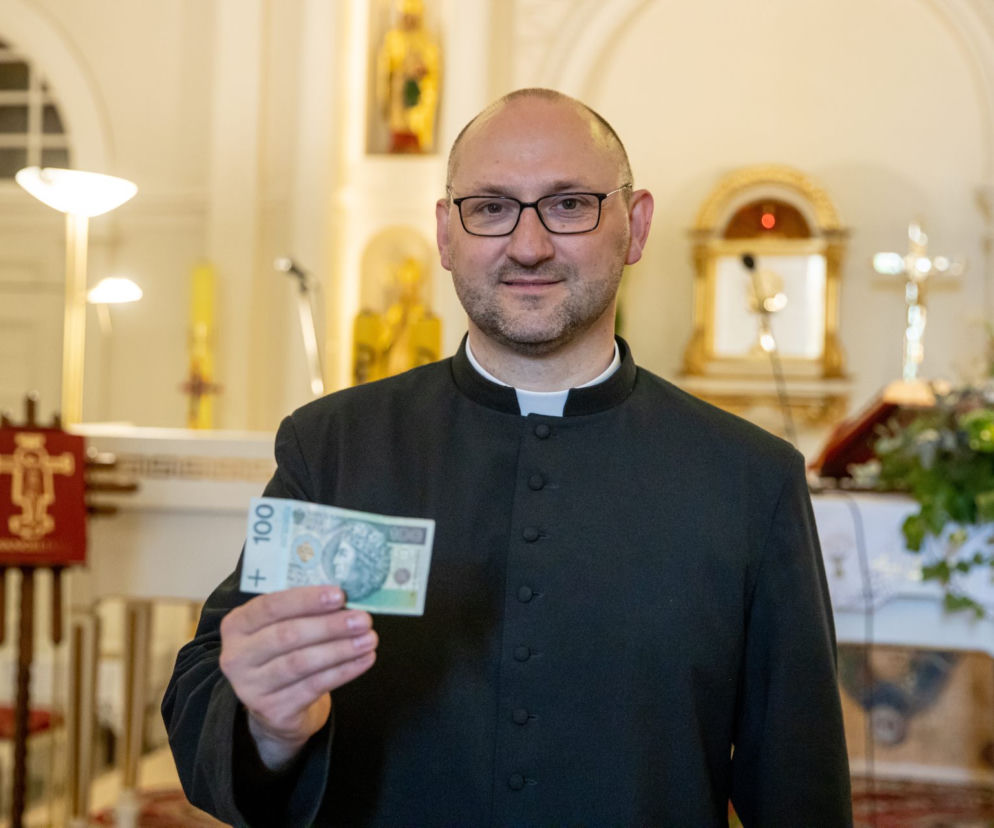 Ksiądz rozdaje pieniądze na mszy