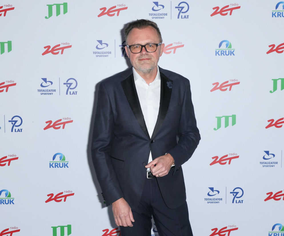 Prezes Polska Press Robert Feluś w ciemnym garniturze na tle ścianki z logotypami. O nowym zarządzie pisze SE Superbiz.