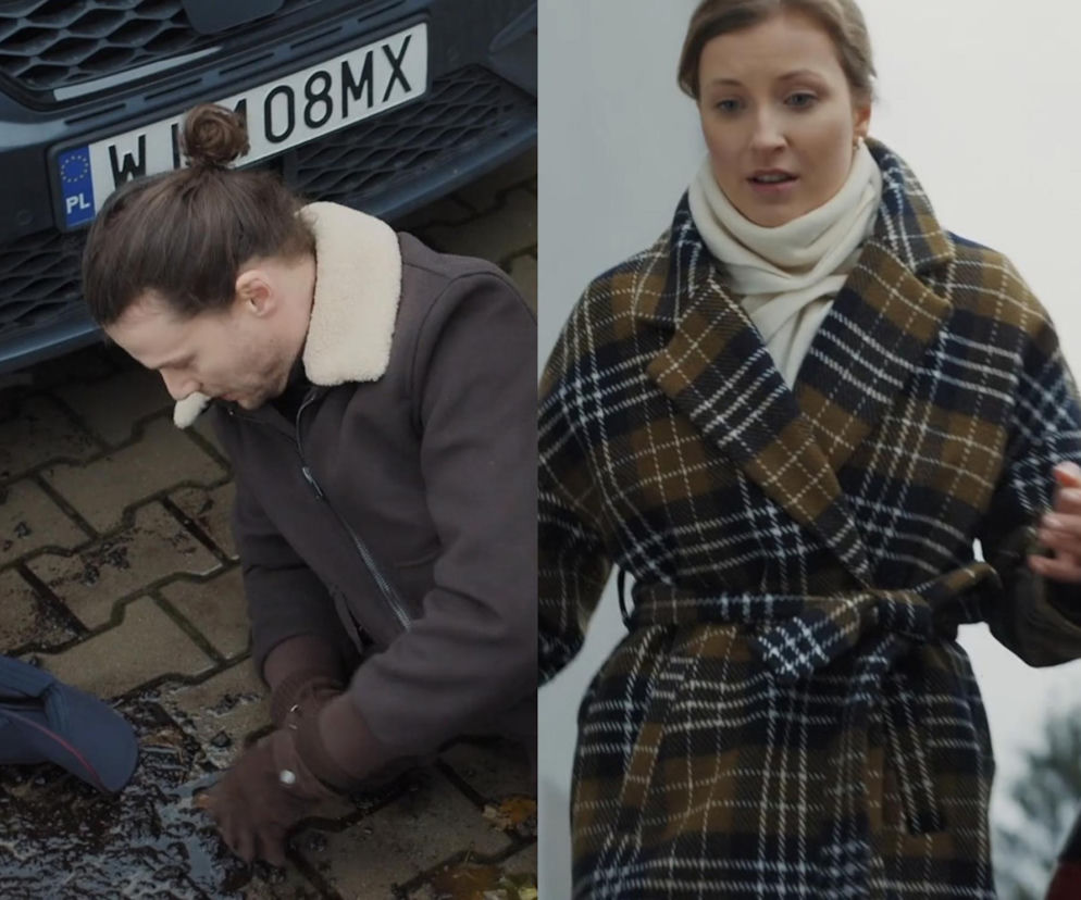 Mężczyzna z kucykiem, schylony przy mokrej nawierzchni obok samochodu z tablicą rejestracyjną W108MX, oraz zaskoczona kobieta w kraciastej, brązowo-czarnej kurtce. Na Super Seriale przeczytasz o potrąceniu Mikołaja przez Natalkę w M jak miłość.