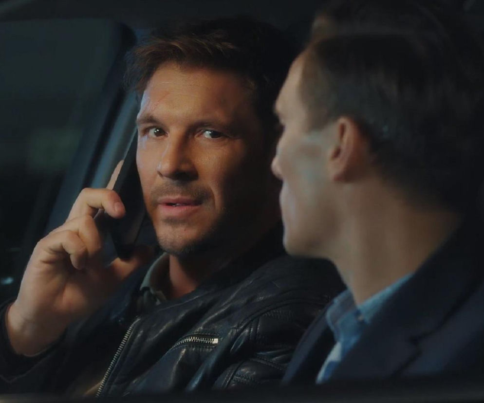 Marcin Chodakowski z M jak miłość rozmawia przez telefon w aucie obok Jakuba Karskiego. O serialu przeczytasz na Eska.