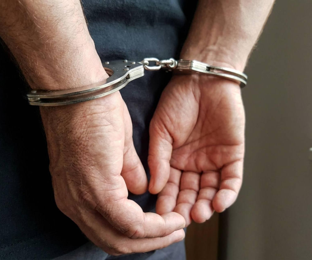 Policja-Ręce mężczyzny w kajdankach